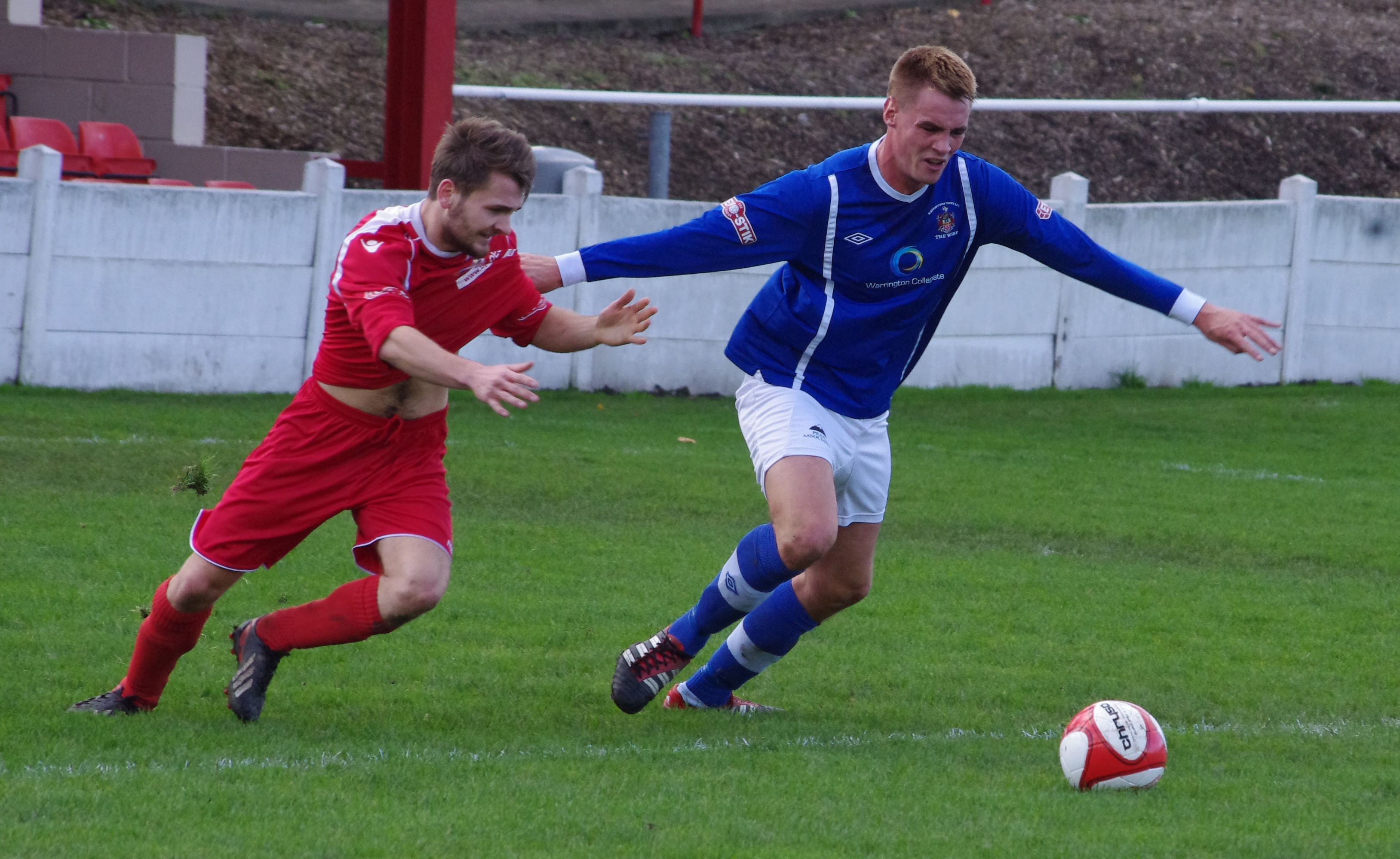 Jimmy Eyles is held by goal-scorer James McCarten