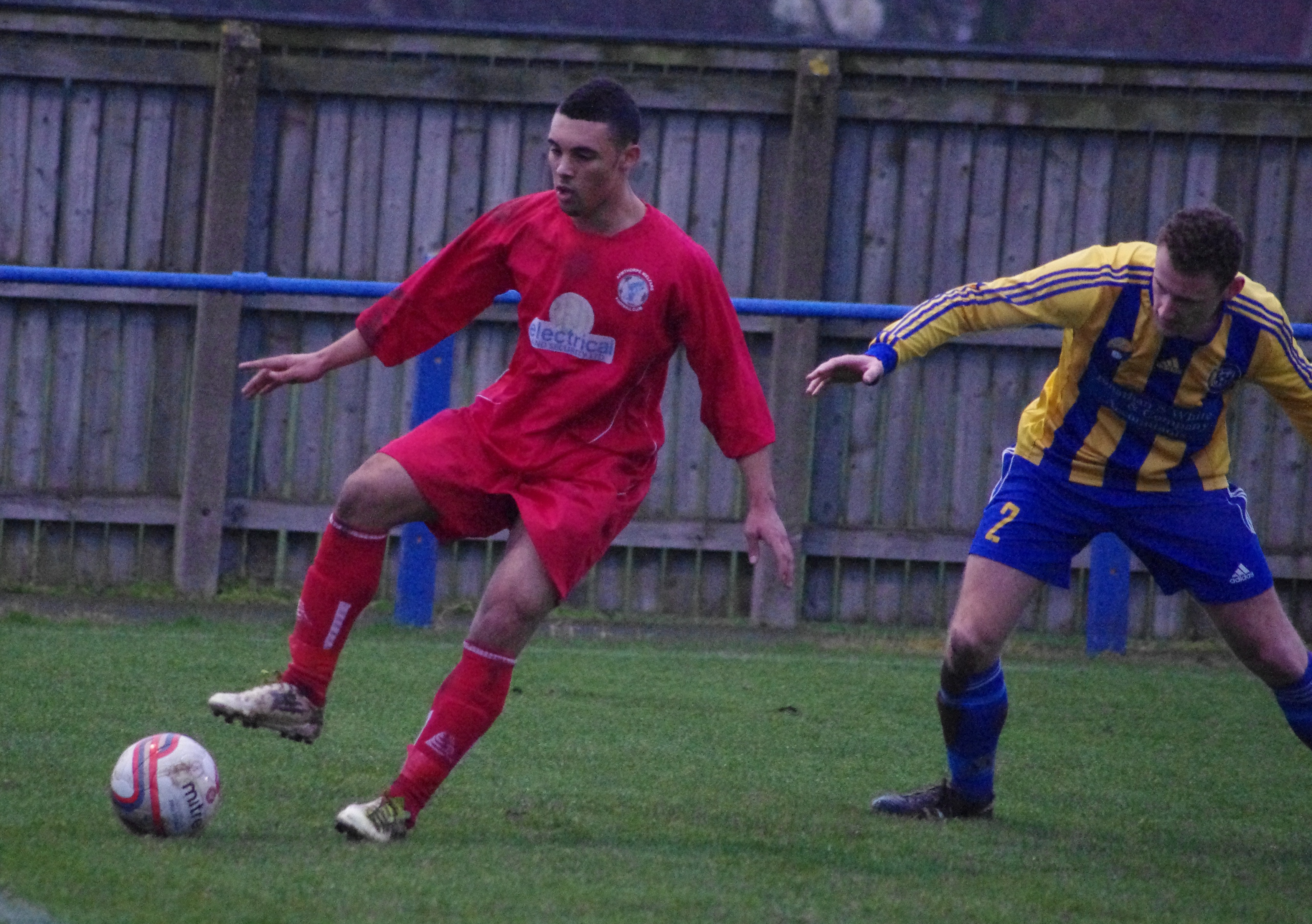 Armthorpe striker Jay Rollins holds off Liam Smith