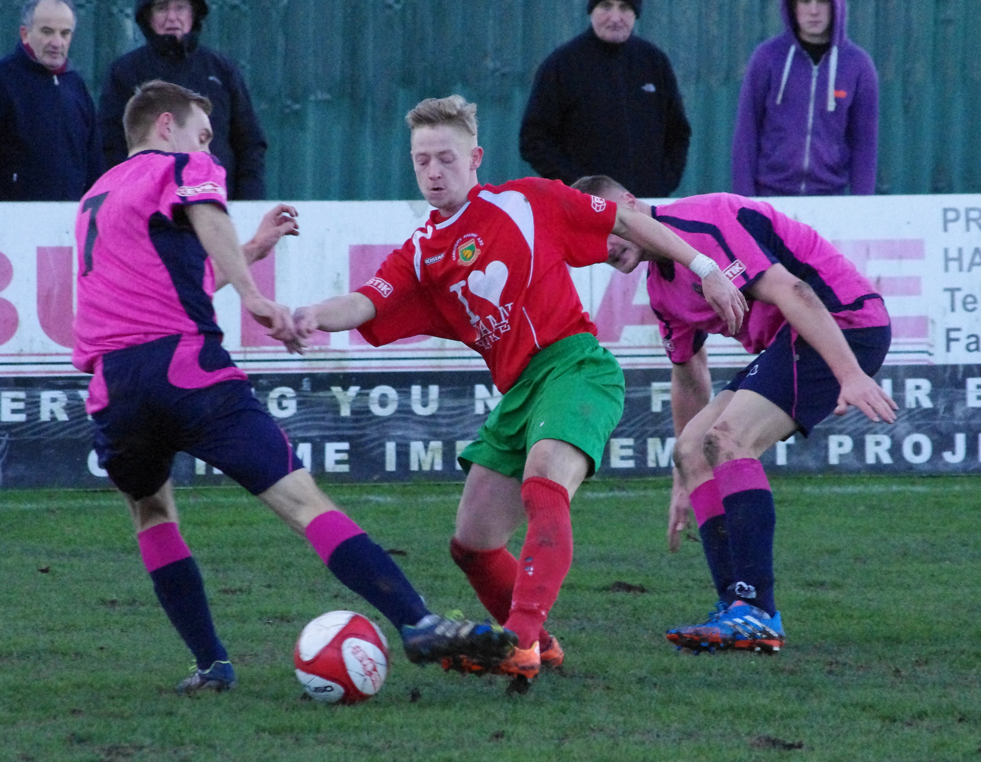 Connor Sellars holds off two Darlington 1883 defenders