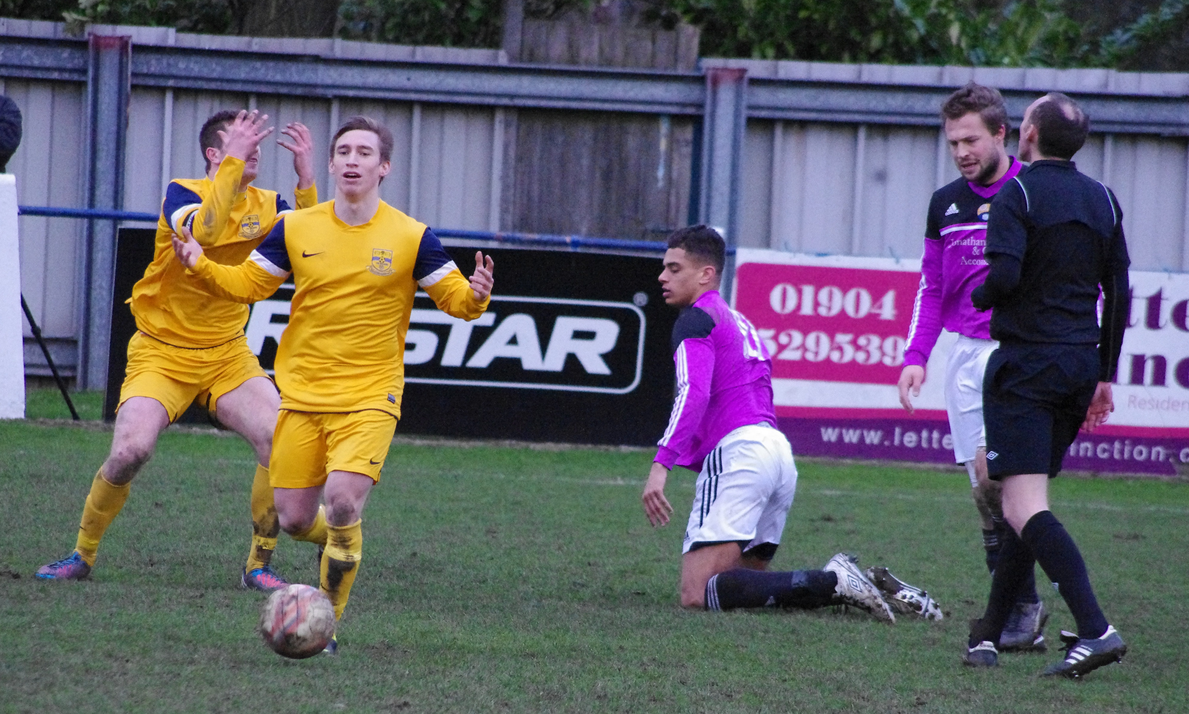 Nick Thompson (left) and Stuart Rice (second left) react to a decision made by referee Mark Dwyer