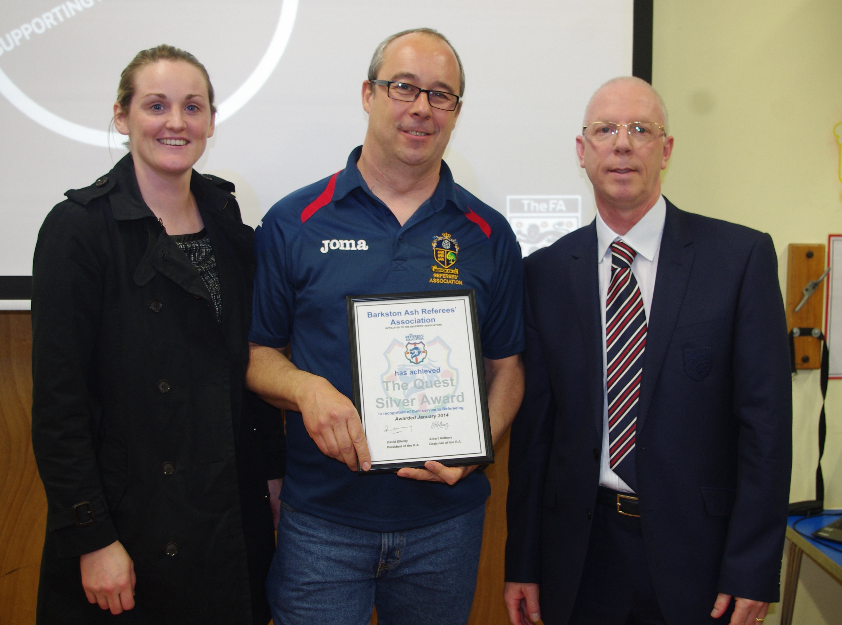 Outgoing Barkston Ash RA chairman Tony Johnson with the Quest Silver award alongside West Riding County FA chief executive officer Hannah Simpson (left) and former Premier League referee Neale Barry (right)