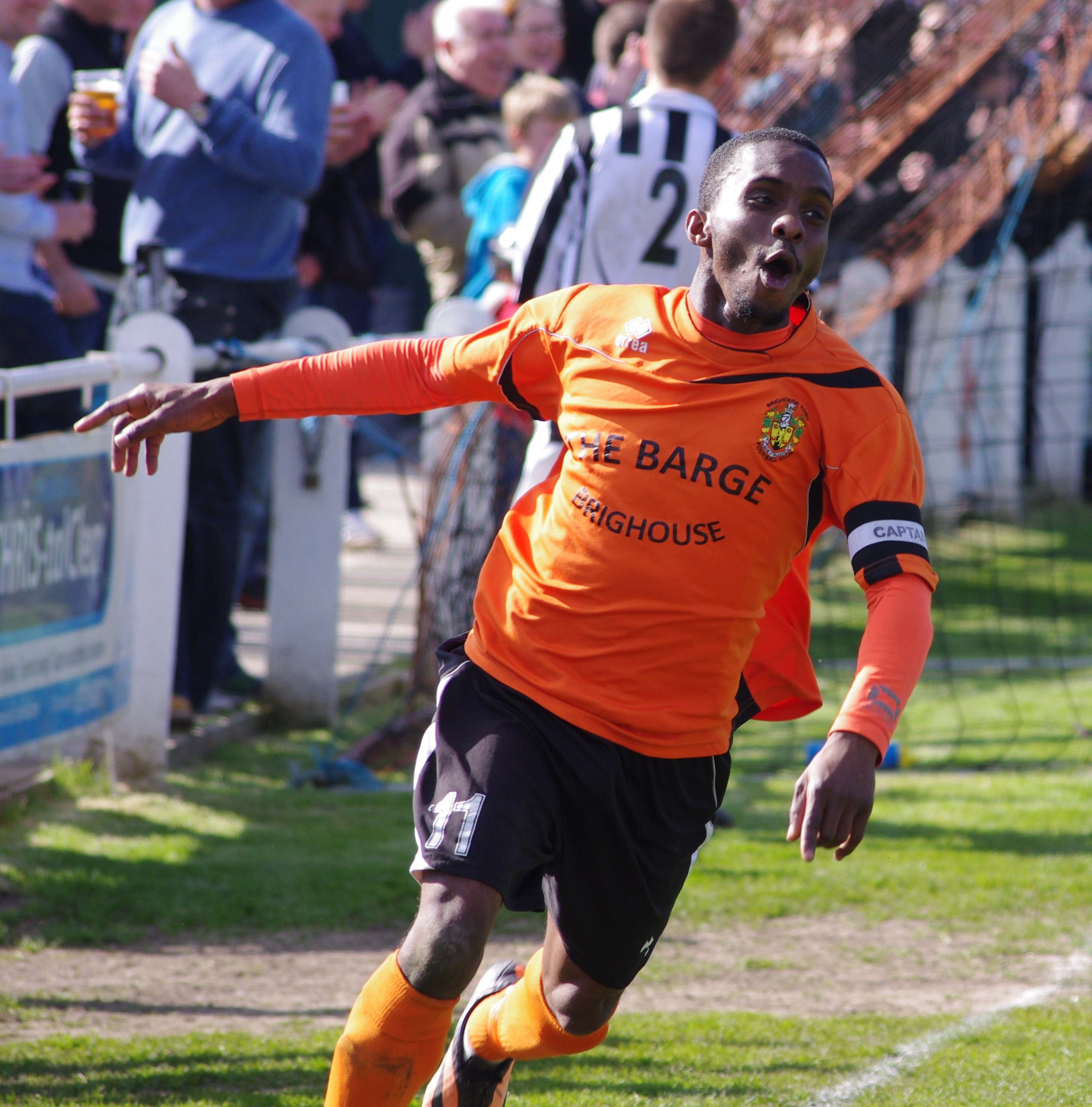 Brighouse Town captain Leon Henry celebrating sealing his side's path to glory yesterday