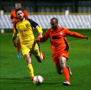 Tadcaster star striker Josh Greening watches Retford United midfielder Ben Muirhead. Picture: Jon Knight