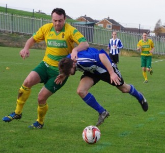 Jimmy Eyles, 'scorer of the third goal, is hauled to the ground