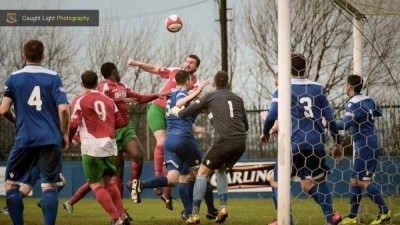 Matt Heath tries to win a header during Harrogate Railway's 4-2 defeat at Farsley AFC