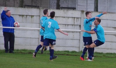 A group of Hemsworth players run to Nick Guest after his cross allowed Robbie Crapper to put the home side ahead