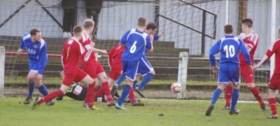 Selby defenders watch on as Forgione side-foots the ball into the net