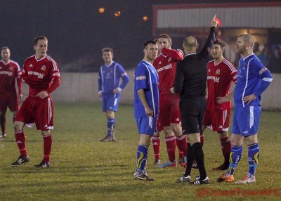 Richard Patterson walks away with a bloodied nose, while Warren Beattie is shown the red card