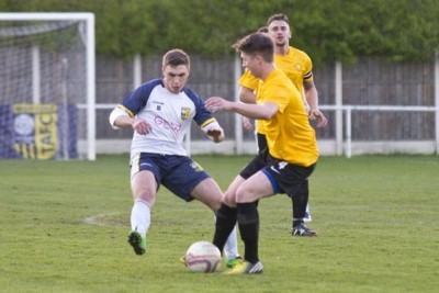 Tadcaster youngster Tom Gore closes down Nostell midfielder James Davies. Picture: Ian Parker