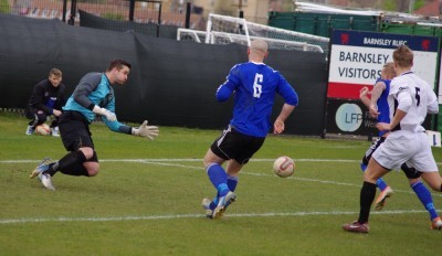 Nostell goalkeeper Ben Saynor cuts out a Shaw Lane attack