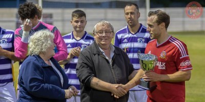 Ossett Town captain Steven Jeff collects the trophy from Steve Kelly's parents Margaret and Joey. Picture: Mark Gledhill