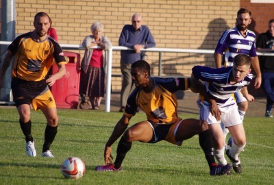 Ossett Albion's Adam Jones battles for the ball