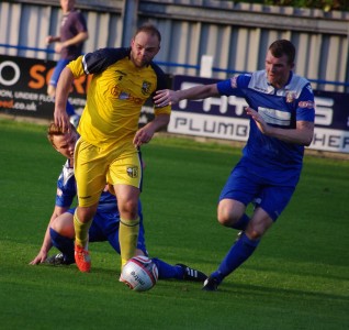 Jimmy Beadle battles with Farsley defender James Riley