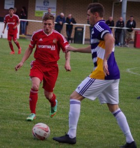 New Ossett midfielder Luke Gordon closes down Hemsworth captain Jason Yates