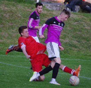 Garforth striker Mark Simpson turns his defender