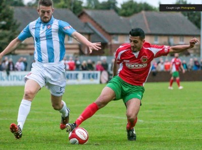 Bad night for Rail, good night for Scarborough. Harrogate striker Vincent Dhesi holds off Ryan Qualter. Picture: Caught Light Photography