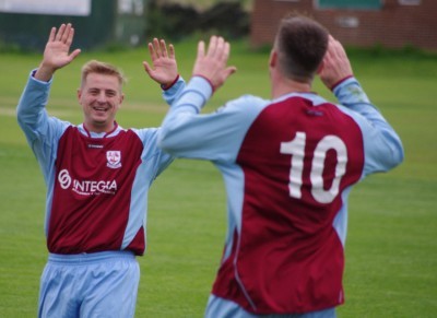 New Penistone striker Steven Kenworthy congratulates Kieron Ryan during one of his final appearances for AFC Emley