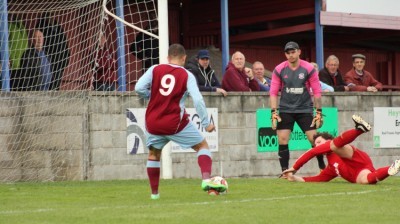 Ash Flynn rolls home one of his five goals in AFC Emley's 10-0 demolition of Winterton Rangers. Picture: Mark Parsons