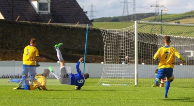 Gavin Allott is taken out by Richard Patterson for Shaw Lane's penalty. Photo: WhiteRosePhotos