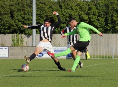 AFC Emley striker Kieran Ryan strikes for goal in his side's 4-3 defeat at Westella VIP