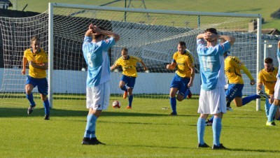 Richard Patterson and Stocksbridge celebrate, while Rugby players look on in disbelief. Picture: Gillian Handisides.