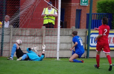 Lewis Taylor scores the rebound from his first penalty which Parkgate goalkeeper Ben Brunt saved