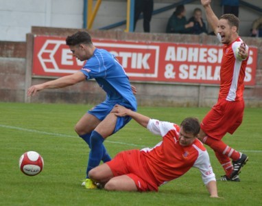 Andrew Fox makes a tackle in Stocksbridge's memorable 2-1 win at Clitheroe last season. Picture: Gillian Handisides.