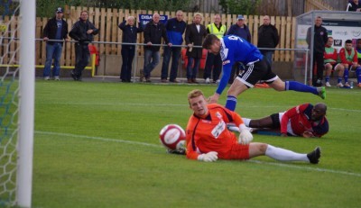 Everyone watches as Gav Allott's early effort hits the post