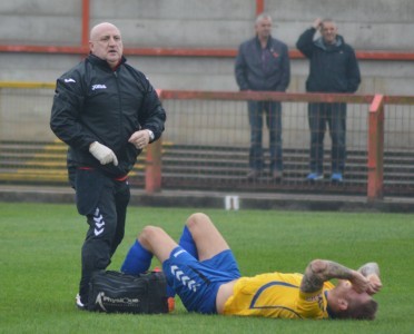 Not the best start: Stocksbridge physio Shaun Handisides signals to the bench to say Cardwell cannot carry on. Picture: Gillian Handisides