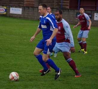 Red carded Hallam midfielder Danny Mullooly holds up the ball