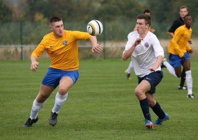 New Maltby Main striker Ryan Carroll (in yellow) in action