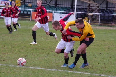 Maltby striker Lewis Benrose attempts to pull away