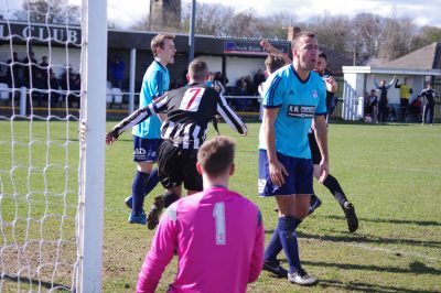 Hemsworth defenders look at each other, while Penistone celebrate