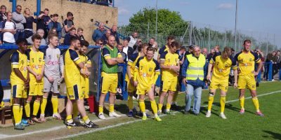 Tadcaster players watch Cleethorpes collect their medals and the trophy