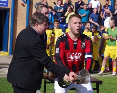 Toolstation NCEL chairman David Morrall presents Cleethorpes captain Alex Flett with the trophy 