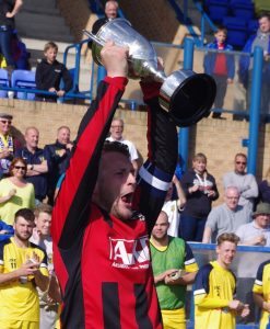 Cleethorpes captain Alex Flett lifts the Toolstation NCEL League Cup trophy