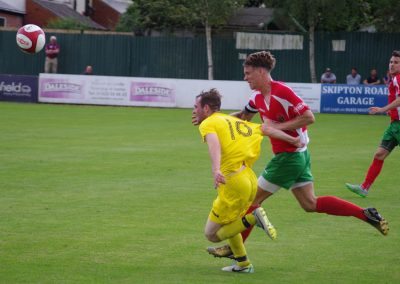 Stimpson attempts to prevent Knaresborough striker Brad Walker racing through on goal