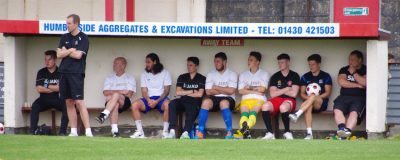 North Ferriby boss Steve Housham (far right) cut a frustrated figure and remained seated for most of the game