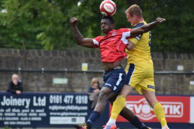 Former Garforth striker Curtly Martin-Wyatt is beaten in the air by Tadcaster defender Gregg Anderson