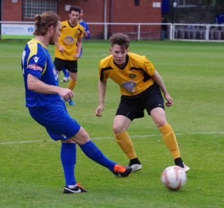 Ossett Town midfielder Brad Riley plays a pass