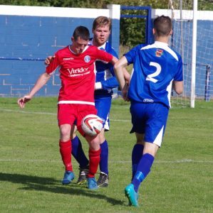 Jimmy Williams (centre behind red attacker) scored while playing at right-back for Pontefract Collieries