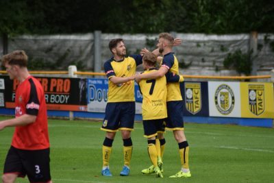 Josh Greening and Conor Sellars congratulate Tom Corner after his goal. Picture: Matthew Appleby 