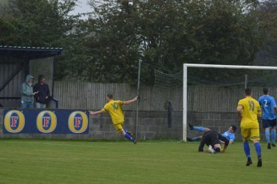 Liversedge striker Vaughan Redford takes on Barton's goalkeeper