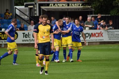 Rob Youhill looks despondent as Farsley celebrate during their FA Cup victory