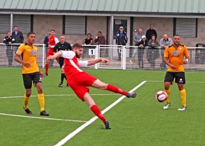 Stocksbridge defender Matt Reay volleys the ball on the artificial surface at Basford. Picture: Ian Revitt