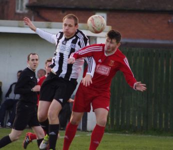 Dale Kelly in an aerial battle with Selby defender Will Ramsay